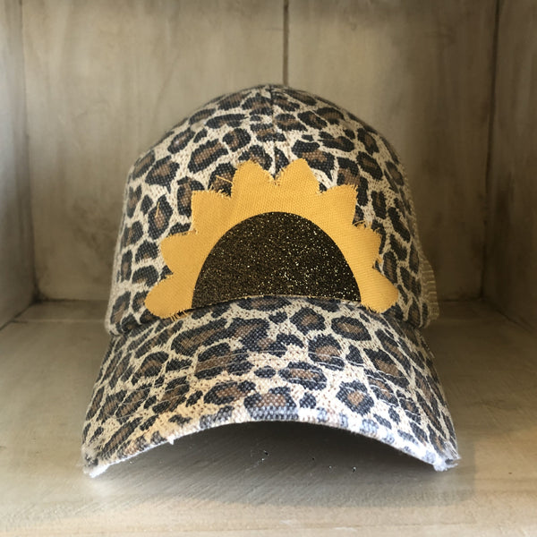 Sunflower hat by BohoGroove with yellow sunflower petals and a black glitter sunflower center on a leopard vintage distressed snapback.