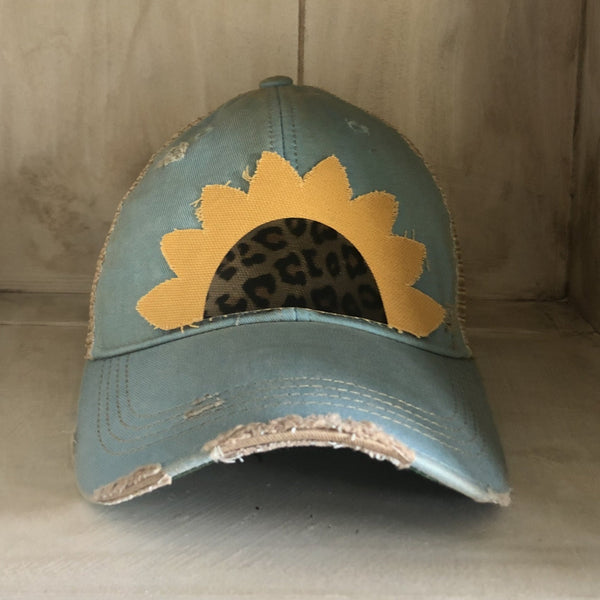 Sunflower hat by BohoGroove featuring yellow sunflower petals and a leopard center on an light blue vintage distressed snapback.