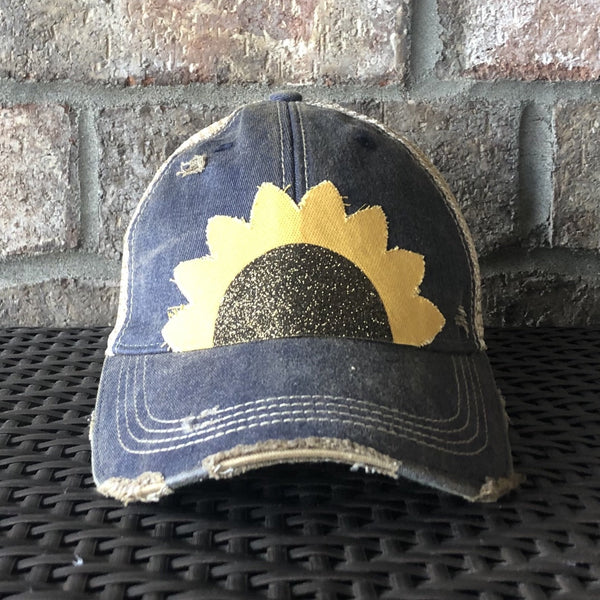 Sunflower hat by BohoGroove with yellow sunflower petals and a black glitter sunflower center on a navy blue vintage distressed snapback.