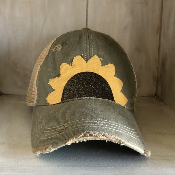 Sunflower hat by BohoGroove with yellow sunflower petals and a black glitter sunflower center on an olive vintage distressed snapback.
