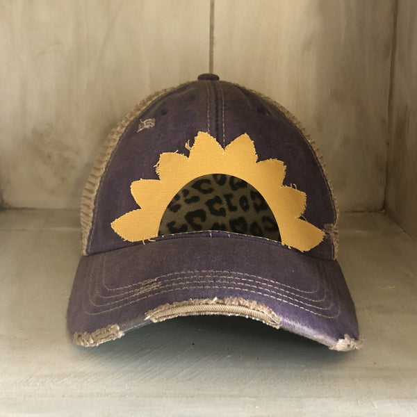 Sunflower hat by BohoGroove featuring yellow sunflower petals and a leopard center on a purple vintage distressed snapback.