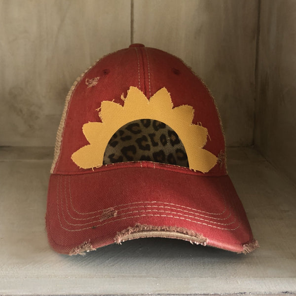 Sunflower hat by BohoGroove featuring yellow sunflower petals and a leopard center on a red vintage distressed snapback.