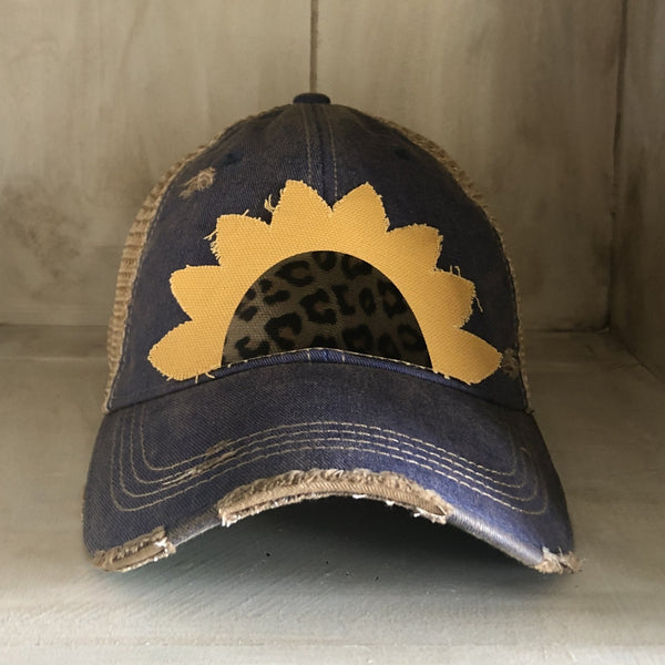 Sunflower hat by BohoGroove featuring yellow sunflower petals and a leopard center on a royal blue vintage distressed snapback.