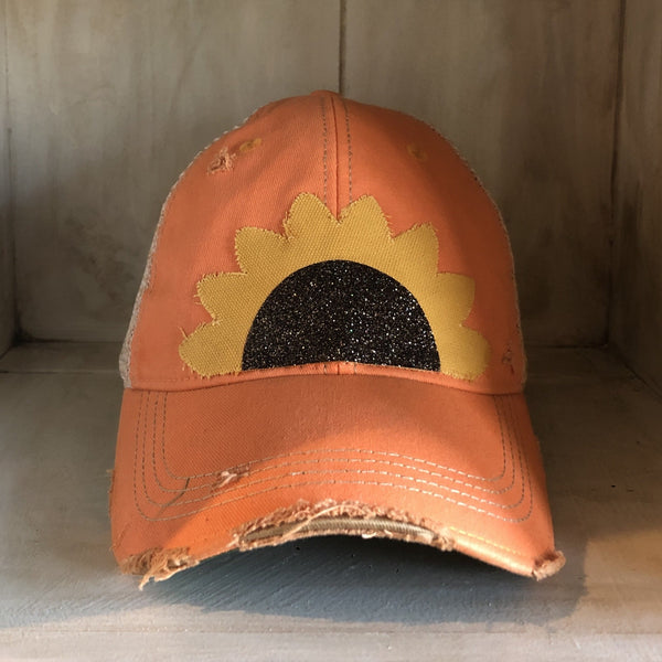 Sunflower hat by BohoGroove with yellow sunflower petals and a black glitter sunflower center on a sherbet vintage distressed snapback.