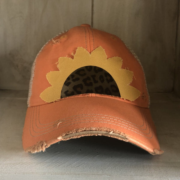 Sunflower hat by BohoGroove featuring yellow sunflower petals and a leopard center on a sherbet vintage distressed snapback.