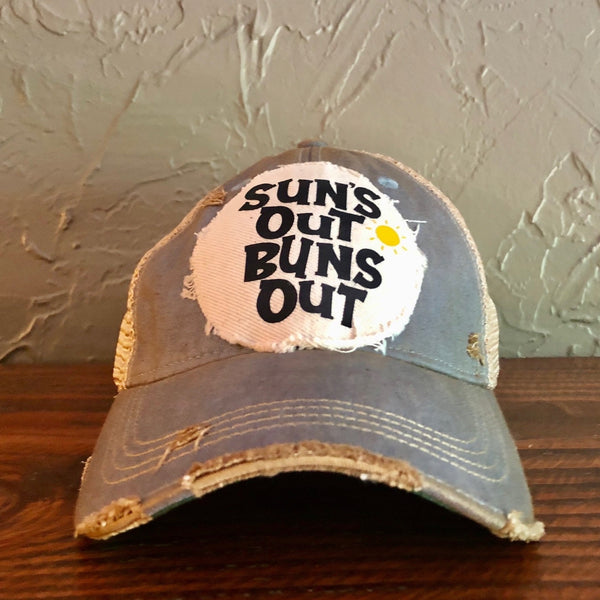 Suns Out Buns Out hat by BohoGroove with black lettering and yellow sun graphic on distressed off-white patch on light blue vintage distressed snapback.