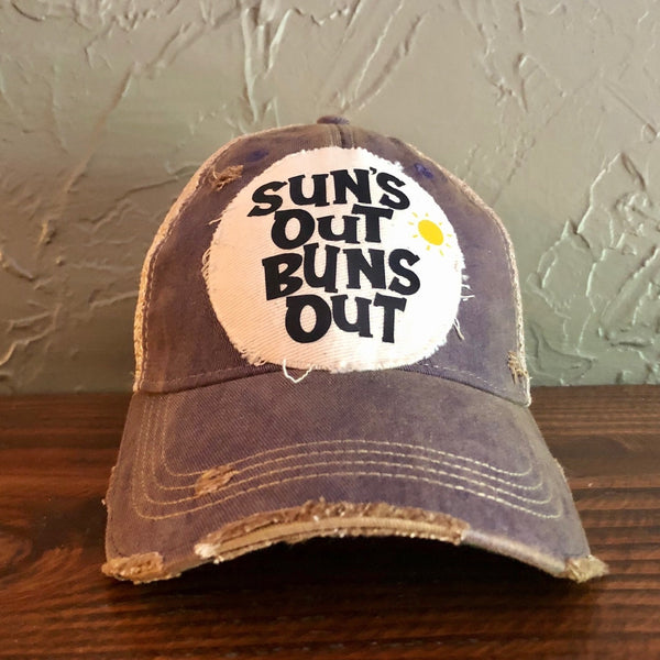 Suns Out Buns Out hat by BohoGroove with black lettering and yellow sun graphic on distressed off-white patch on purple vintage distressed snapback.