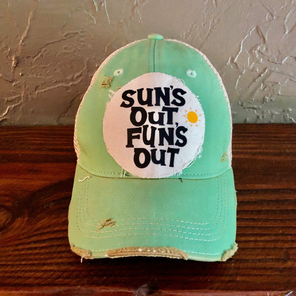 Sun's Out Fun's Out hat by BohoGroove with black Sun's Out Fun's Out lettering and yellow sun graphic on distressed off-white patch on a mint green vintage distressed snapback.