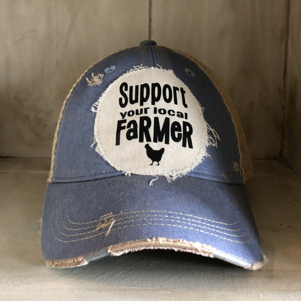 Support Your Local Farmer hat by BohoGroove with black Support Your Local Farmer lettering and chicken graphic on a distressed off-white patch on a light blue vintage distressed snapback.