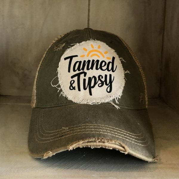 Tanned and Tipsy Hat by BohoGroove on a distressed black snapback trucker hat with hand-applied patch design and vintage weathered style.