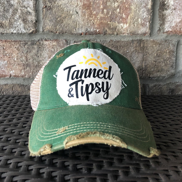Tanned and Tipsy Hat by BohoGroove on a distressed green snapback trucker hat with hand-applied patch design and vintage weathered style.