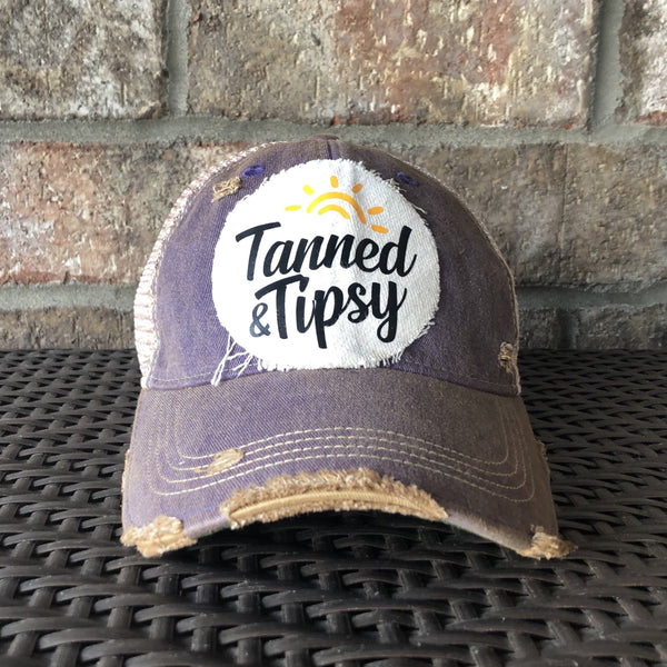 Tanned and Tipsy Hat by BohoGroove on a distressed purple snapback trucker hat with hand-applied patch design and vintage weathered style.