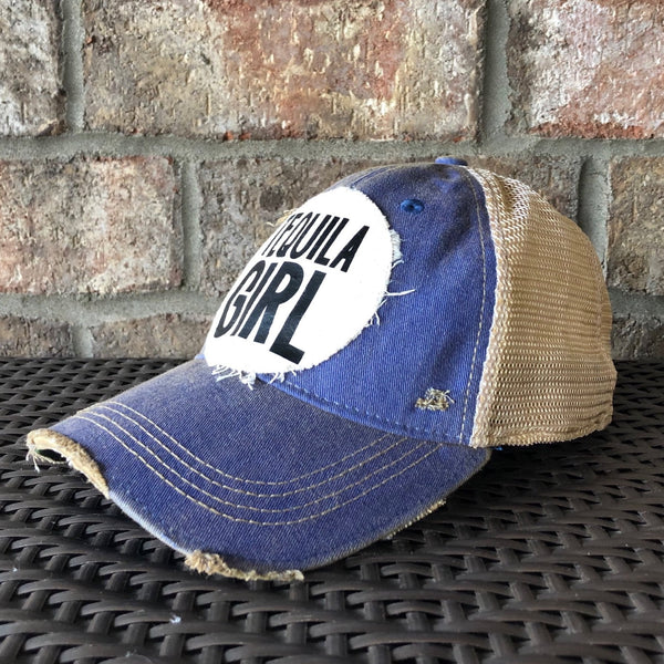 Right side view of a Tequila Girl hat by BohoGroove with black Tequila Girl lettering on a distressed off-white patch on a royal blue vintage distressed snapback trucker hat.