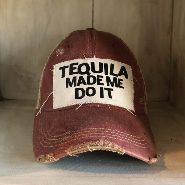 Tequila Made Me Do It hat by BohoGroove featuring bold black Tequila Made Me Do It lettering on a distressed off-white patch on a brick red vintage distressed snapback trucker hat.