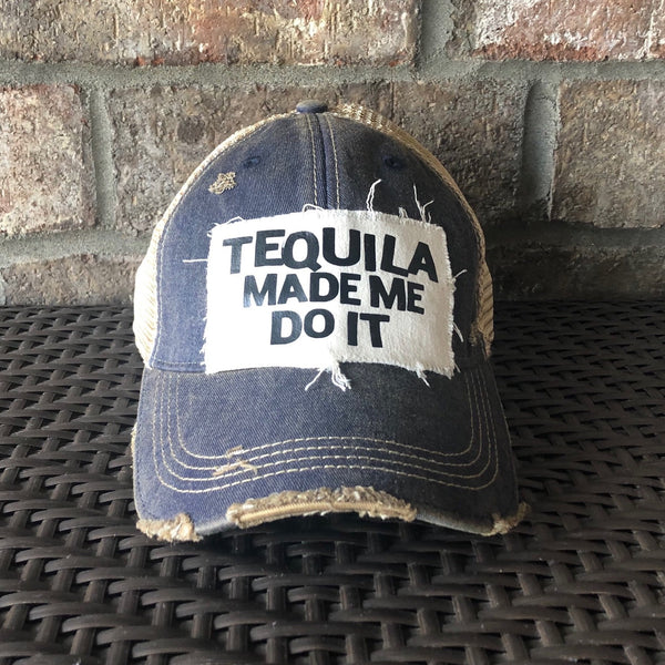 Tequila Made Me Do It hat by BohoGroove featuring bold black Tequila Made Me Do It lettering on a distressed off-white patch on a navy blue vintage distressed snapback trucker hat.