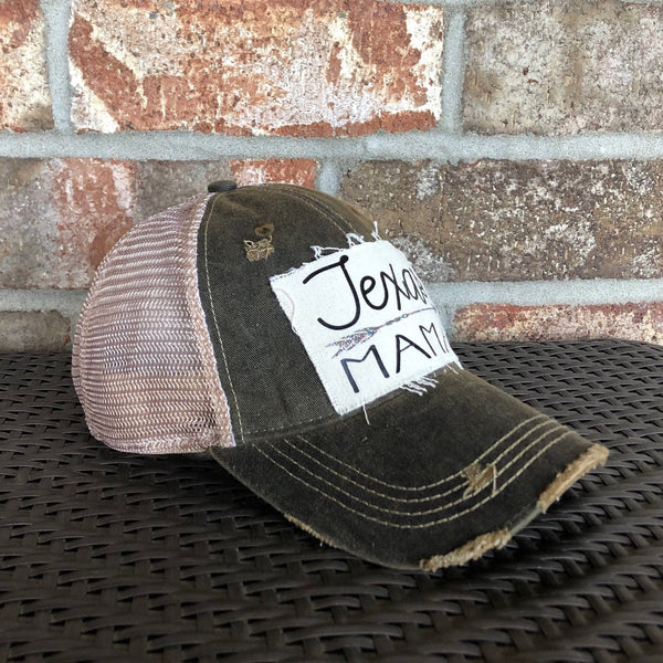 Texas Mama hat by BohoGroove with black Texas Mama lettering and arrow graphic on a distressed off-white patch on a black vintage distressed snapback left side