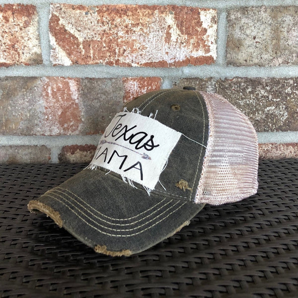 Texas Mama hat by BohoGroove with black Texas Mama lettering and arrow graphic on a distressed off-white patch on a black vintage distressed snapback left side