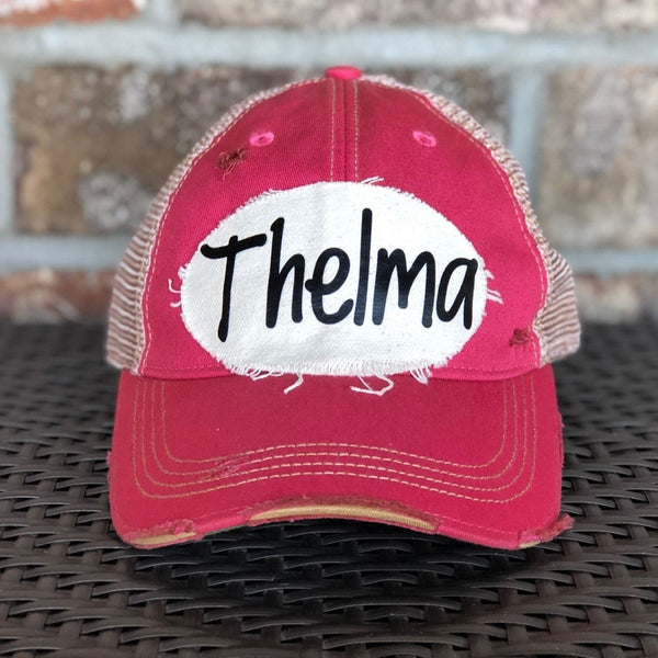 Thelma hat by BohoGroove with black Thelma lettering on a distressed off-white patch on a pink vintage distressed snapback trucker hat.
