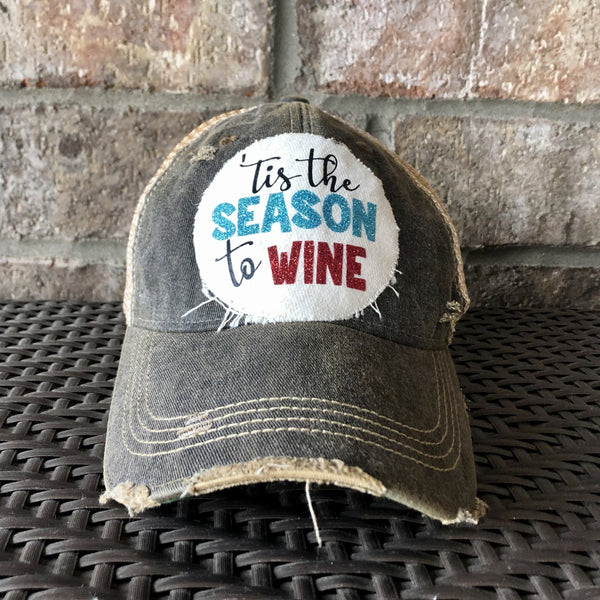 Tis the Season to Wine hat by BohoGroove with black script lettering, blue glitter Season lettering, and red glitter Wine lettering on a distressed off-white custom patch on a black vintage distressed snapback.