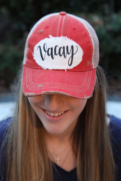Model wearing Vacay hat by BohoGroove with black Vacay lettering on distressed off-white patch and red vintage distressed snapback