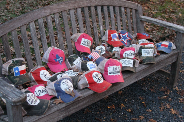 a variety of BohoGroove hats laying on a bench