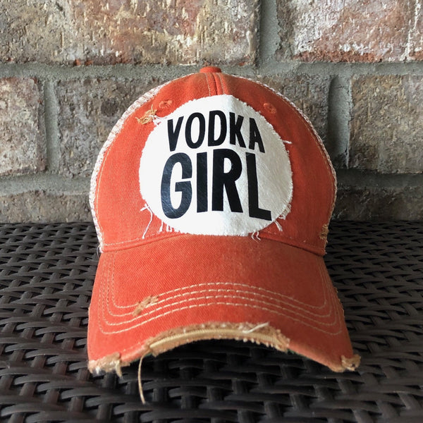 Vodka Girl hat by BohoGroove with black Vodka Girl lettering on a distressed off-white patch on an orange vintage distressed snapback trucker hat.