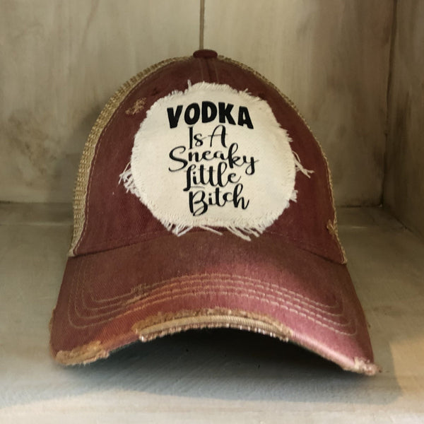 Vodka Is a Sneaky Little Bitch hat by BohoGroove with black lettering on a distressed off-white patch on a brick red vintage distressed snapback.