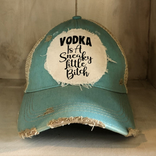 Vodka Is a Sneaky Little Bitch hat by BohoGroove with black lettering on a distressed off-white patch on an ocean blue vintage distressed snapback.