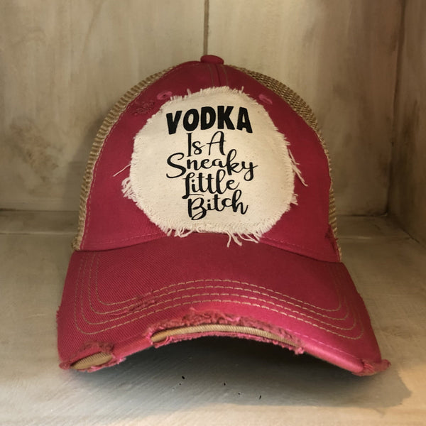Vodka Is a Sneaky Little Bitch hat by BohoGroove with black lettering on a distressed off-white patch on a pink vintage distressed snapback.