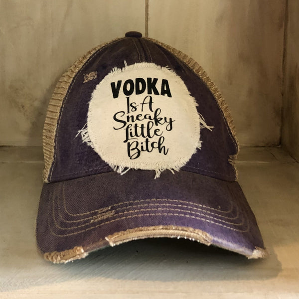 Vodka Is a Sneaky Little Bitch hat by BohoGroove with black lettering on a distressed off-white patch on a purple vintage distressed snapback.