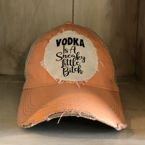 Vodka Is a Sneaky Little Bitch hat by BohoGroove with black lettering on a distressed off-white patch on a sherbet vintage distressed snapback.