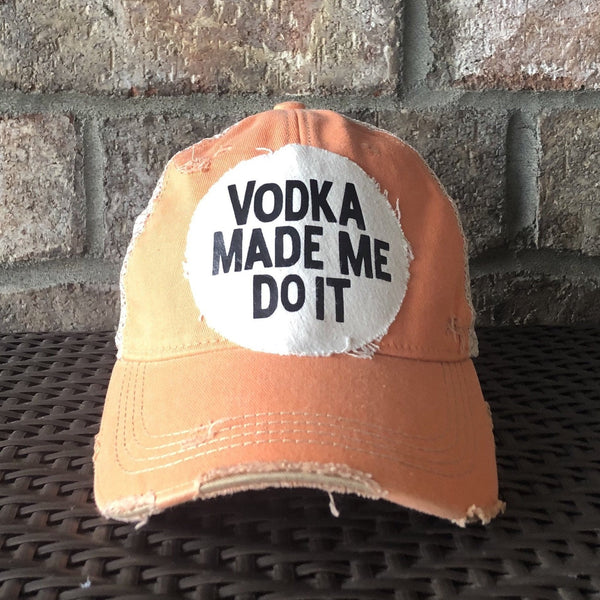 Vodka Made Me Do It hat by BohoGroove with black lettering on a distressed off-white patch on a sherbet vintage distressed snapback.