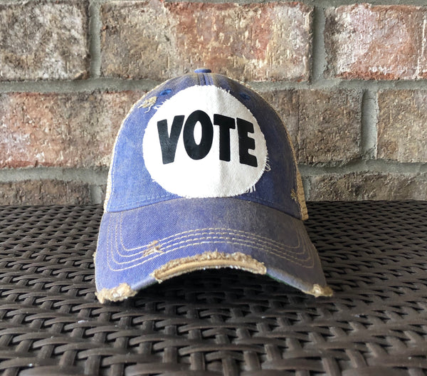 Vote hat by BohoGroove with bold black VOTE lettering on distressed off-white patch and royal blue vintage distressed snapback