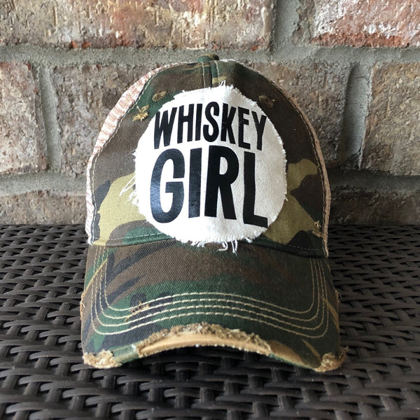 Whiskey Girl hat by BohoGroove with black lettering on a distressed off-white patch on a camo vintage distressed snapback.