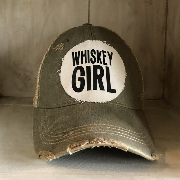 Whiskey Girl hat by BohoGroove with black lettering on a distressed off-white patch on an olive vintage distressed snapback.