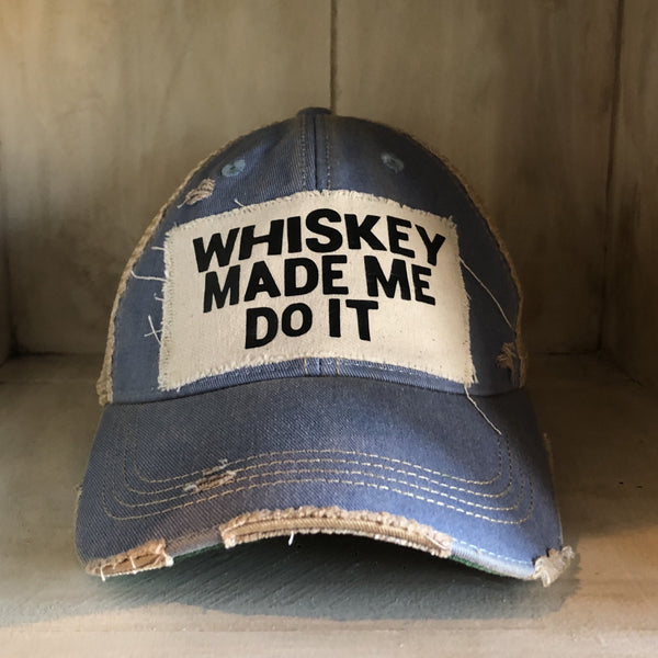 Whiskey Made Me Do It hat by BohoGroove with black Whiskey Made Me Do It lettering on a distressed off-white patch on a light blue vintage distressed snapback trucker hat.