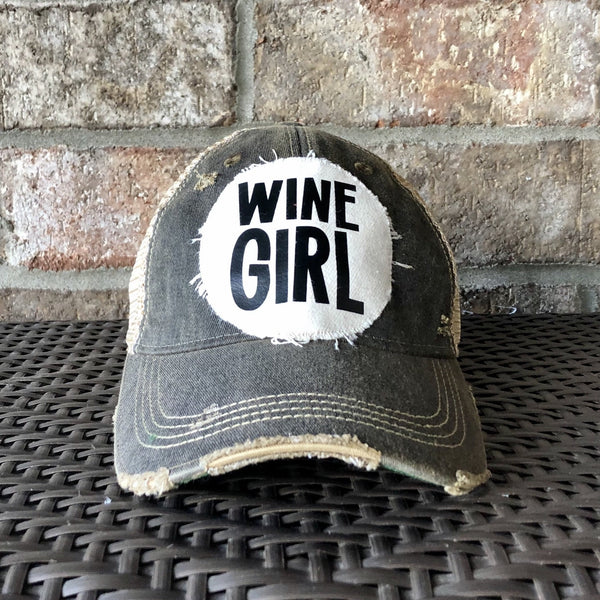 Wine Girl hat by BohoGroove with black Wine Girl lettering and wine glass graphic on a distressed off-white patch on a black vintage distressed snapback trucker hat.