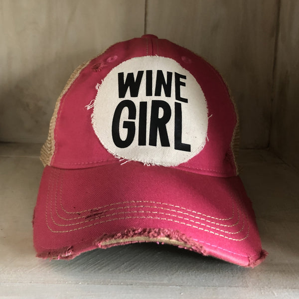 Wine Girl hat by BohoGroove with black Wine Girl lettering and wine glass graphic on a distressed off-white patch on a pink vintage distressed snapback trucker hat.