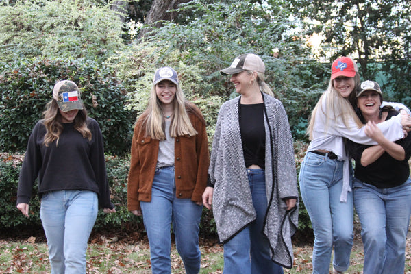 five women wearing BohoGroove vintage distressed snapback hats while outdoors