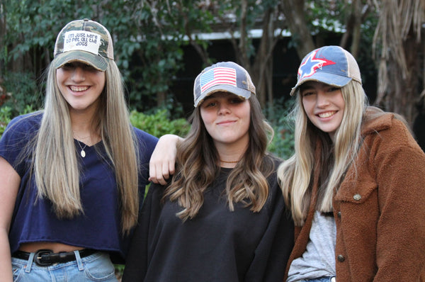 Lifestyle photo of women wearing BohoGroove vintage distressed patriotic snapback hats including the American Flag hat 