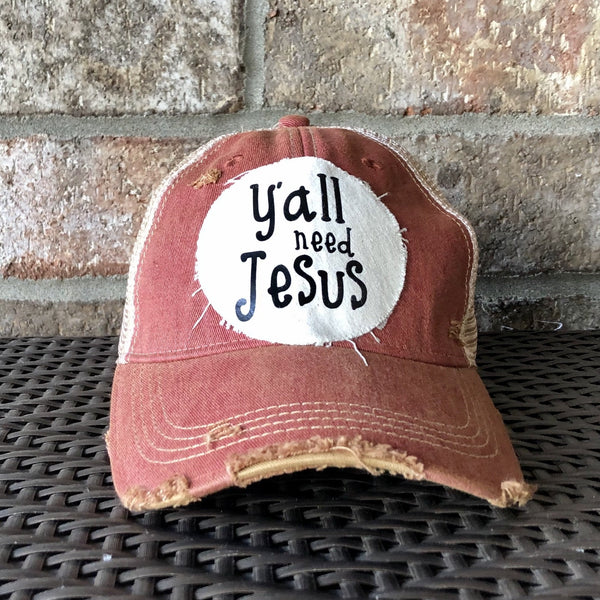 Y’all Need Jesus Hat by BohoGroove with black Y’all Need Jesus lettering on distressed off-white patch on a brick red vintage distressed snapback