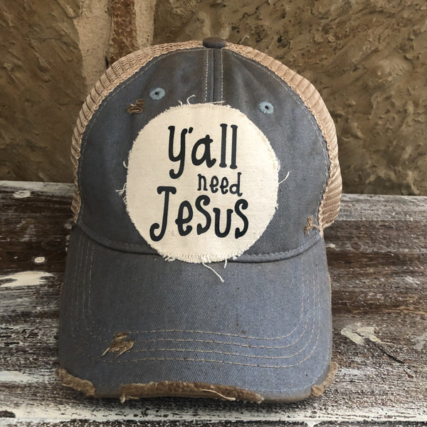 Y’all Need Jesus Hat by BohoGroove with black Y’all Need Jesus lettering on distressed off-white patch on a light blue vintage distressed snapback
