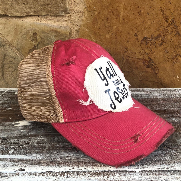 Y’all Need Jesus Hat by BohoGroove with black Y’all Need Jesus lettering on distressed off-white patch on a pink vintage distressed snapback left side 