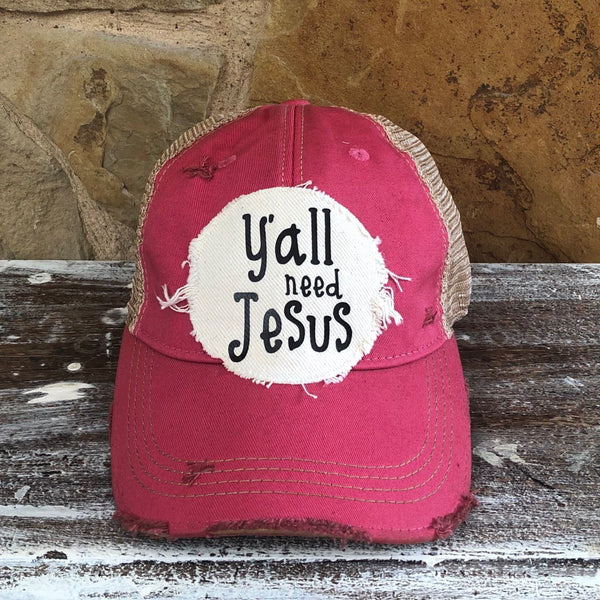 Y’all Need Jesus Hat by BohoGroove with black Y’all Need Jesus lettering on distressed off-white patch on a pink vintage distressed snapback